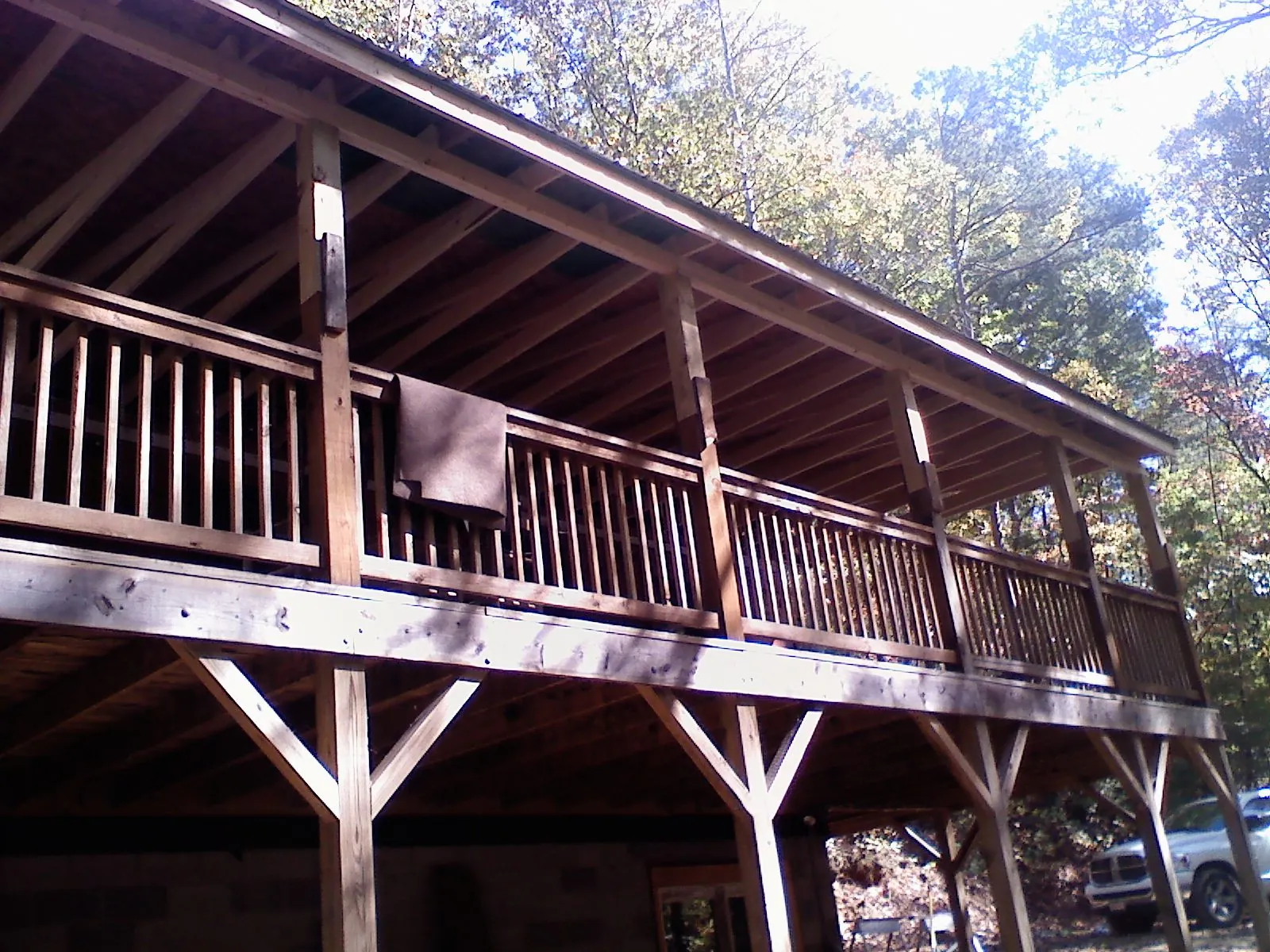 Timber framing under a new elevated porch and deck in Thayer